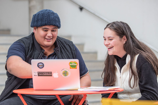 Two students viewing the laptop
