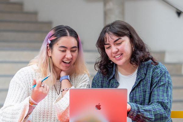 two tertiary students looking at the laptop
