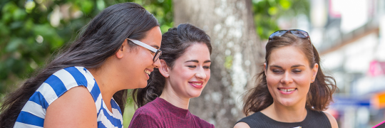 Group of tertiary students studying outside the campus.