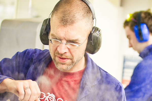 An instructor guiding a trainee in industrial tasks