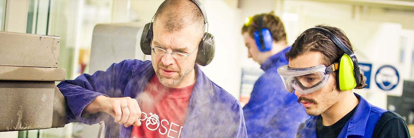 An instructor guiding a trainee in industrial tasks