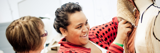 Fashion student draping woven flax on a mannequin. 