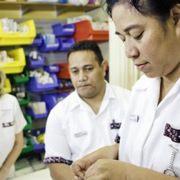 Nursing students work while a supervisor watches them