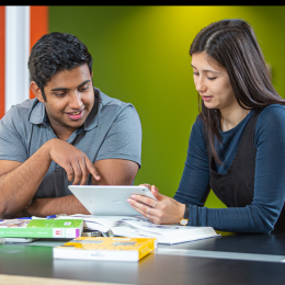 two staff discuss technology issues 